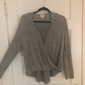 Gray sweater with open cross in the front